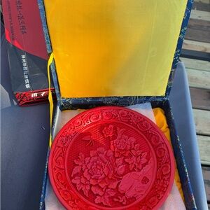 Red Decorative Plate with Floral Design
